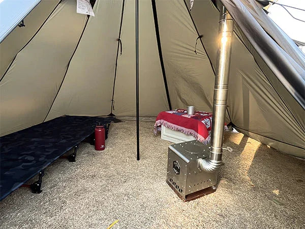 Inside a spacious canvas tent with a cot, portable stove, and camping gear on the ground